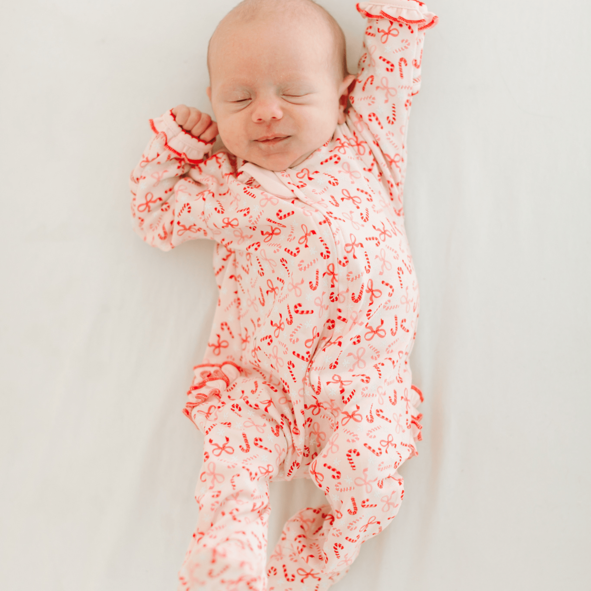 Candy Cane Lane Print Ruffle Zip Footie - Magnolia BabyFootie