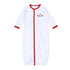White Magnolia Baby converter gown with red trim and embroidered dog, foam finger, and football helmet on the chest.