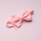 Pink bow on a light pink background