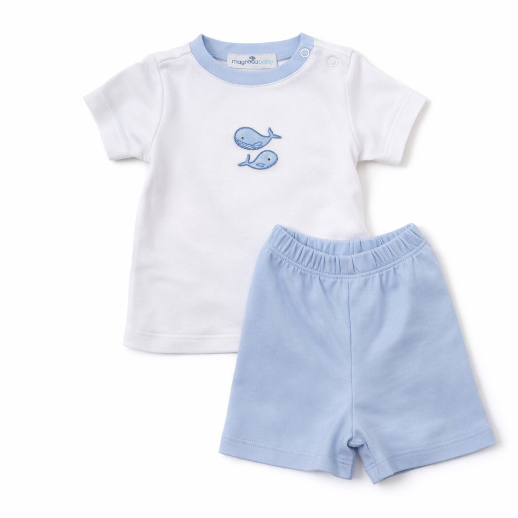 Baby outfit with white shirt and light blue shorts on a white background