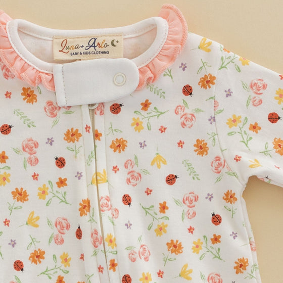 Bugs and Blossoms Ruffle Zip Footie - Magnolia BabyFootie