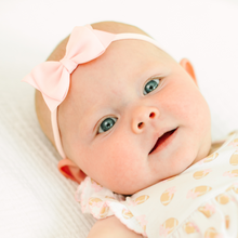  baby girl wearing a pink headband