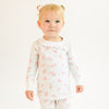 Child wearing a floral ballerina pajama set on a white background