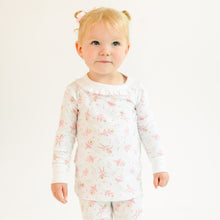 Child wearing a floral ballerina pajama set on a white background