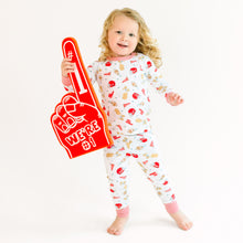  Child wearing bulldog footall pajamas with a foam hand on a white background