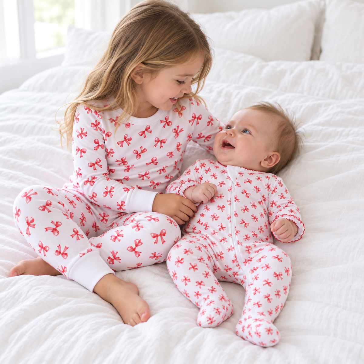 Sisters wearing Scarlett Bows pajamas and matching zip footie