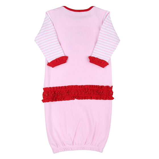 Vestido de vuelta rosa con volantes y apliques de Papá Noel que guiñan un ojo